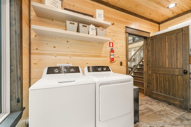 washroom with independent washer and dryer, wooden walls, and wood ceiling