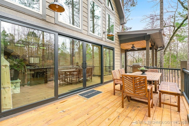 wooden terrace featuring ceiling fan