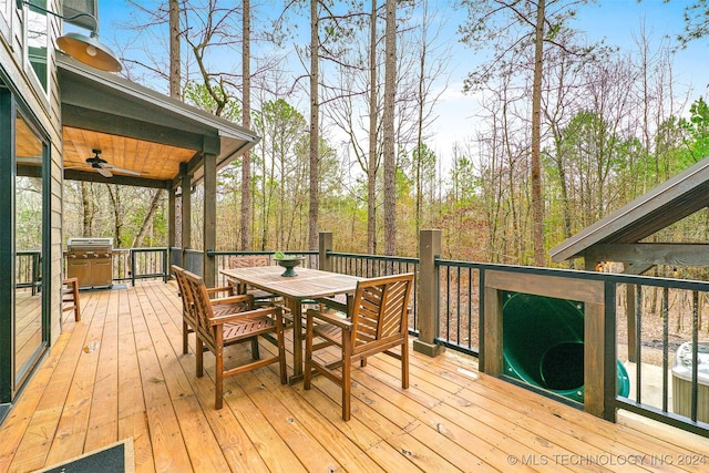 deck featuring ceiling fan and a grill