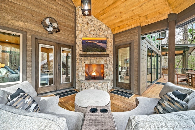 view of patio with french doors and an outdoor stone fireplace