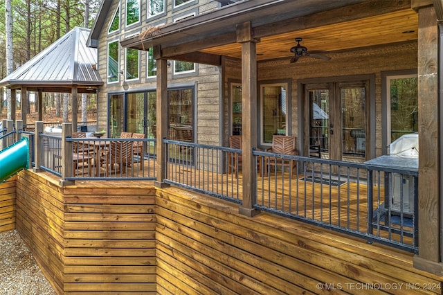 wooden terrace featuring ceiling fan