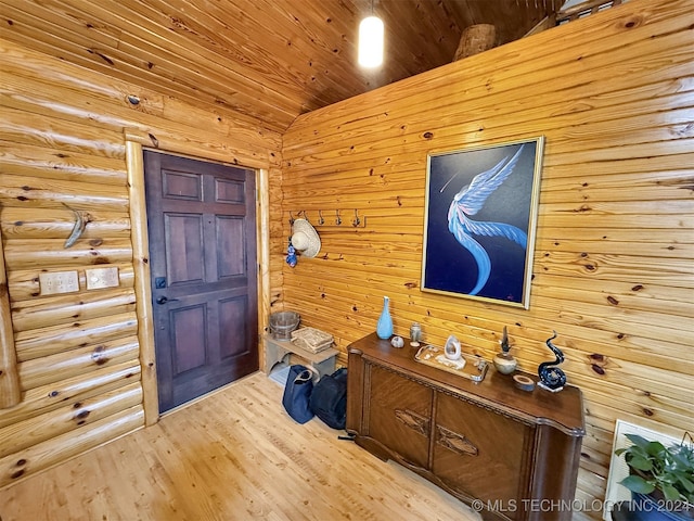 foyer with light hardwood / wood-style floors, wood ceiling, and vaulted ceiling