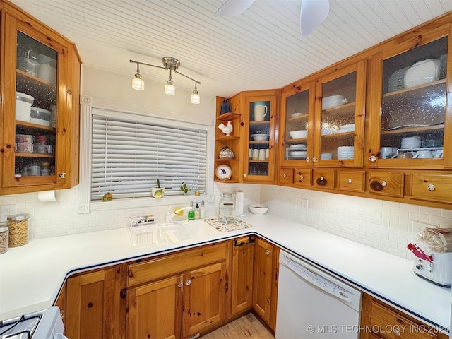 kitchen featuring dishwasher, backsplash, light hardwood / wood-style flooring, ceiling fan, and decorative light fixtures