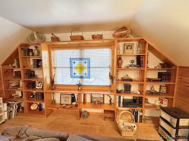 living area with wood-type flooring and vaulted ceiling