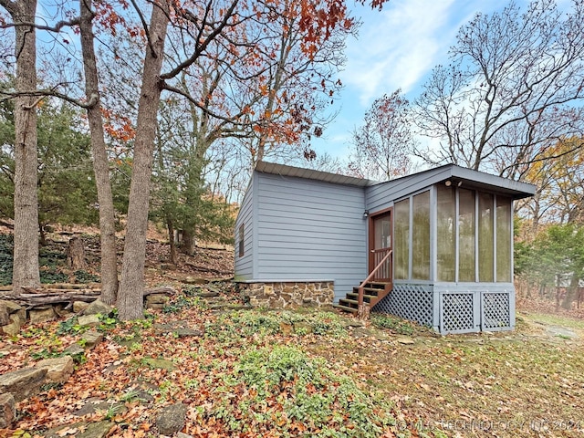 back of property with a sunroom