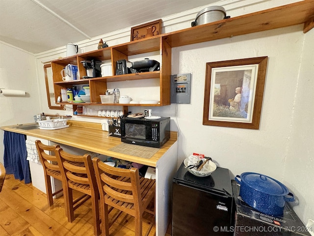 bar with hardwood / wood-style flooring