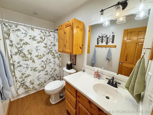 bathroom with toilet, vanity, a shower with shower curtain, and hardwood / wood-style flooring