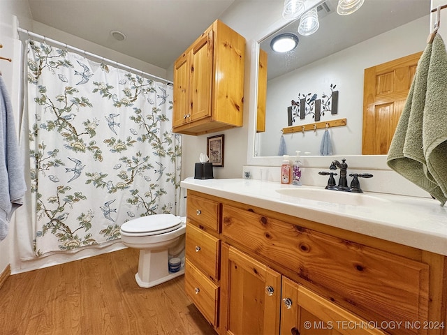 bathroom featuring hardwood / wood-style floors, vanity, and toilet