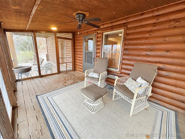 sunroom featuring ceiling fan and wooden ceiling