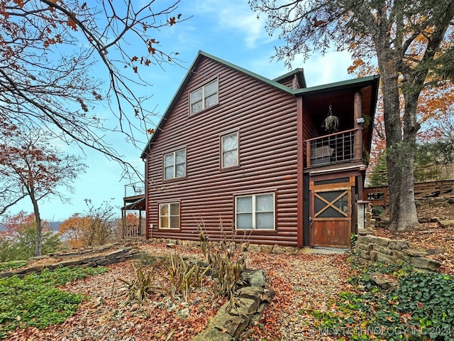 view of home's exterior with a balcony