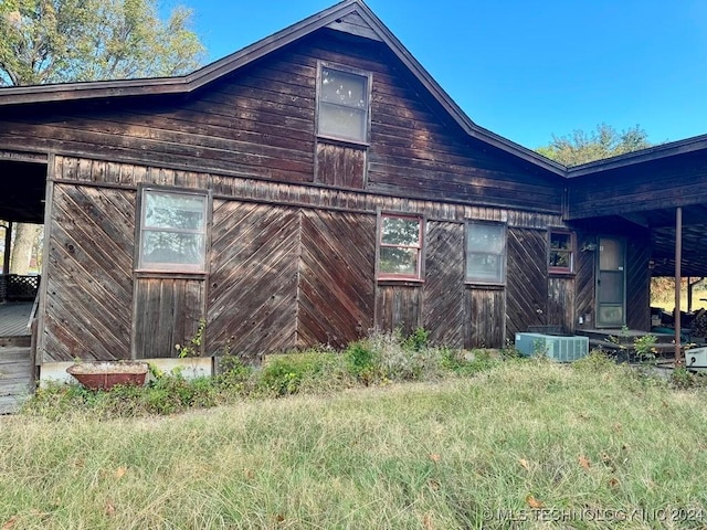 view of side of home with central AC