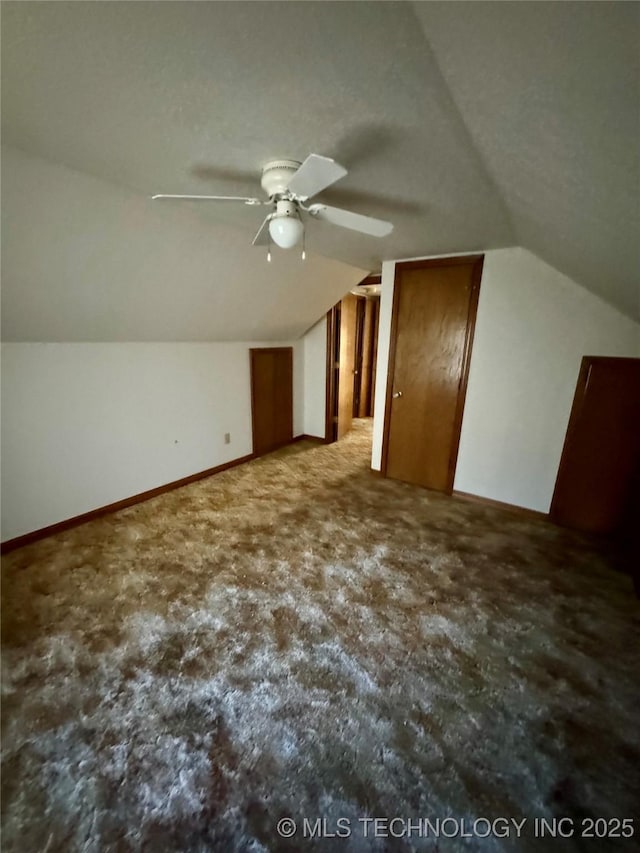 additional living space featuring ceiling fan and vaulted ceiling