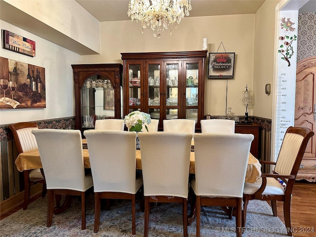 dining space with a chandelier and wood-type flooring