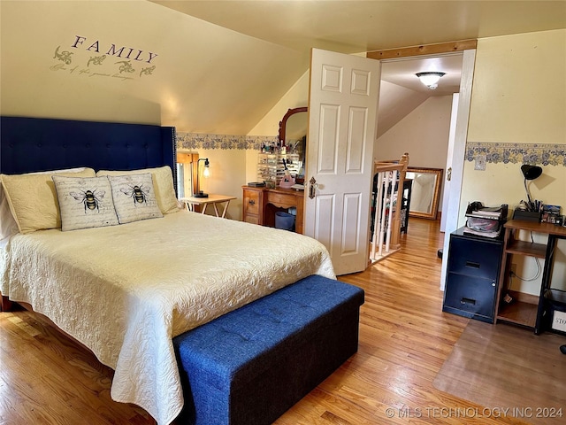 bedroom featuring wood-type flooring and lofted ceiling