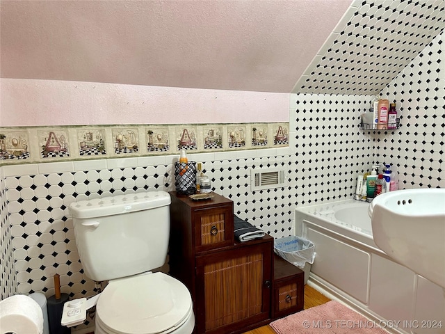 bathroom with toilet, tile walls, and a bathing tub