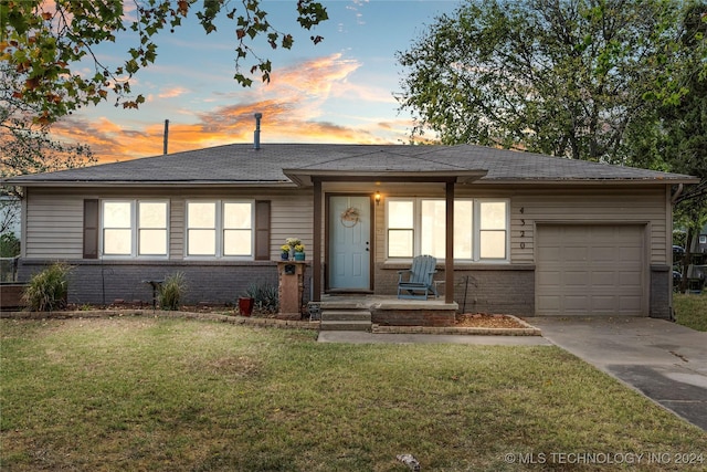 view of front of home featuring a garage and a lawn