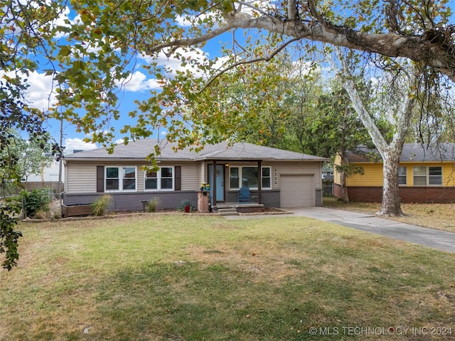 single story home with a front yard and a garage