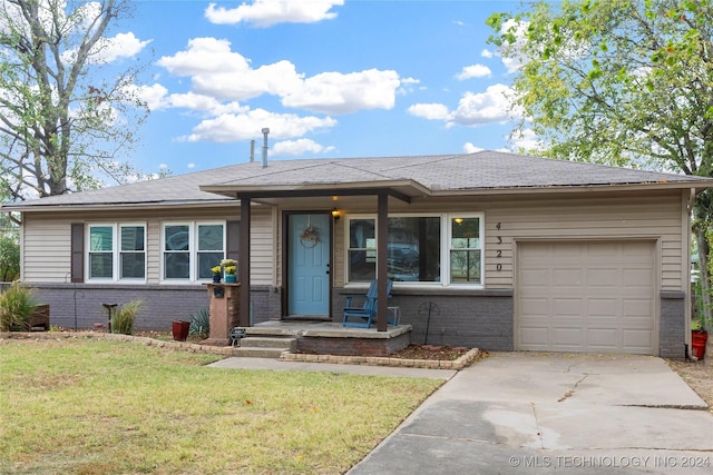 view of front of home with a front yard and a garage