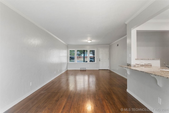 unfurnished living room featuring crown molding and dark hardwood / wood-style floors