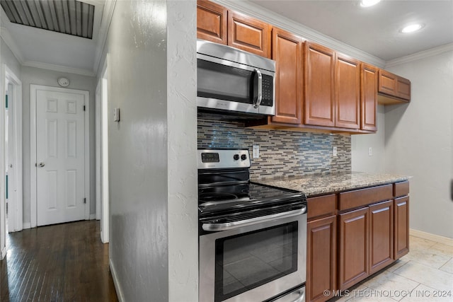 kitchen with backsplash, crown molding, light hardwood / wood-style floors, light stone counters, and stainless steel appliances