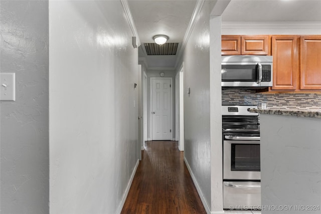 kitchen featuring appliances with stainless steel finishes, dark hardwood / wood-style flooring, tasteful backsplash, and ornamental molding