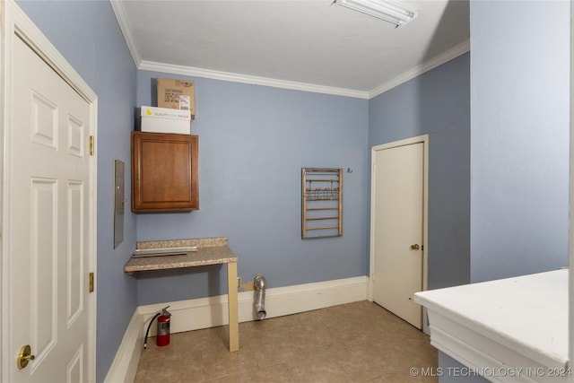 interior space featuring ornamental molding and light tile patterned flooring