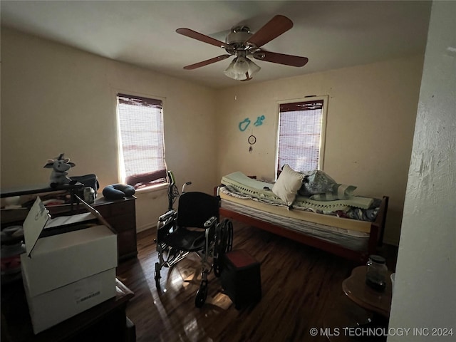 bedroom with ceiling fan and dark wood-type flooring