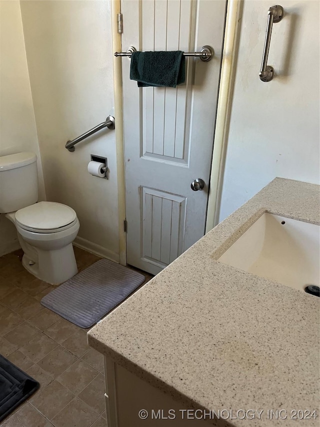 bathroom with tile patterned floors, vanity, and toilet