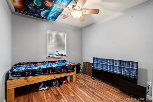 bedroom with ceiling fan and wood-type flooring