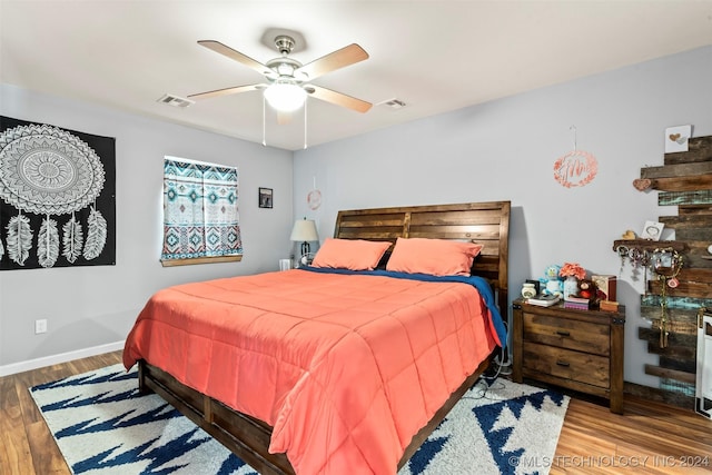 bedroom with hardwood / wood-style flooring and ceiling fan