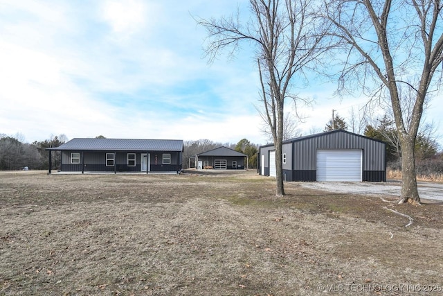 ranch-style home with an outbuilding, a garage, and covered porch