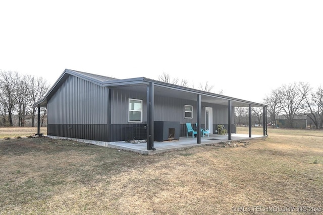 view of side of home with a yard and a patio