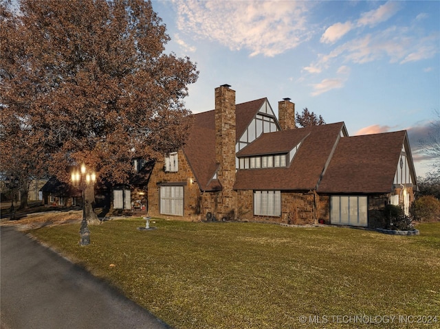 english style home with a yard