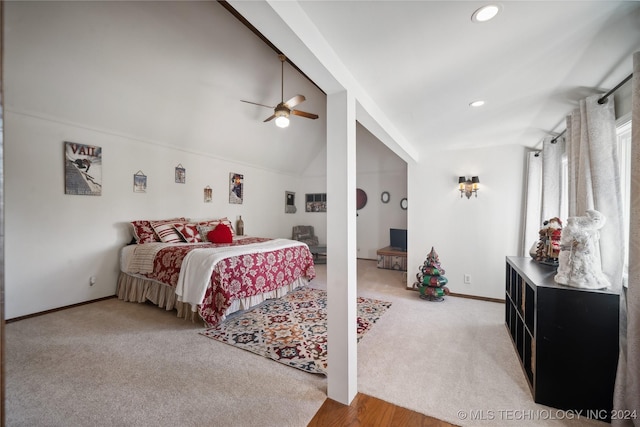 carpeted bedroom with ceiling fan and lofted ceiling