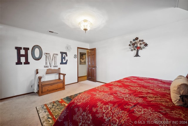 bedroom featuring crown molding and light colored carpet