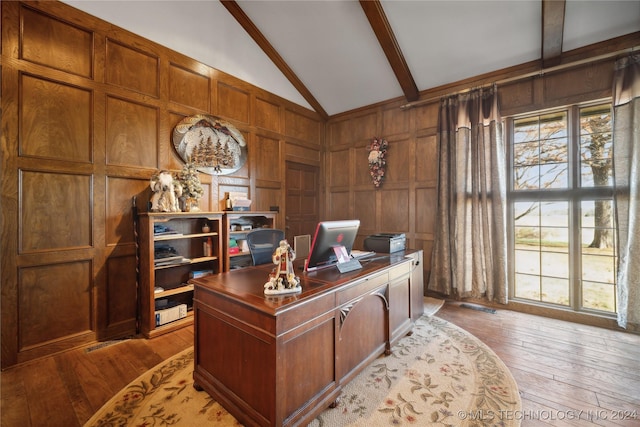 office space featuring wooden walls, light hardwood / wood-style flooring, beamed ceiling, and high vaulted ceiling