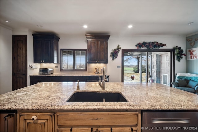7133 S 425th Rd, Inola, OK 74036 - kitchen with open floor plan, crown molding, light stone countertops, and a sink