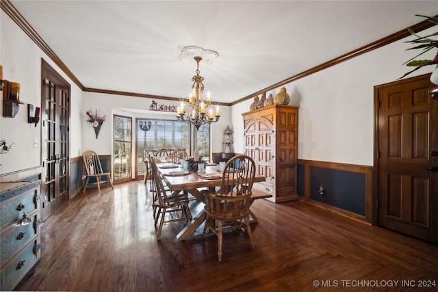 dining area with french doors, dark wood-type flooring, an inviting chandelier, and ornamental molding