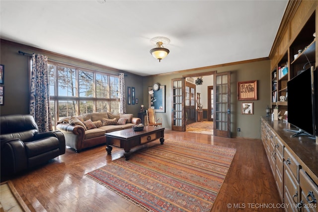 living room featuring wood-type flooring, ornamental molding, and french doors