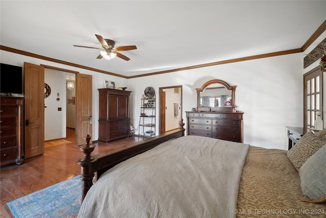 bedroom featuring hardwood / wood-style floors, ceiling fan, ornamental molding, and multiple windows