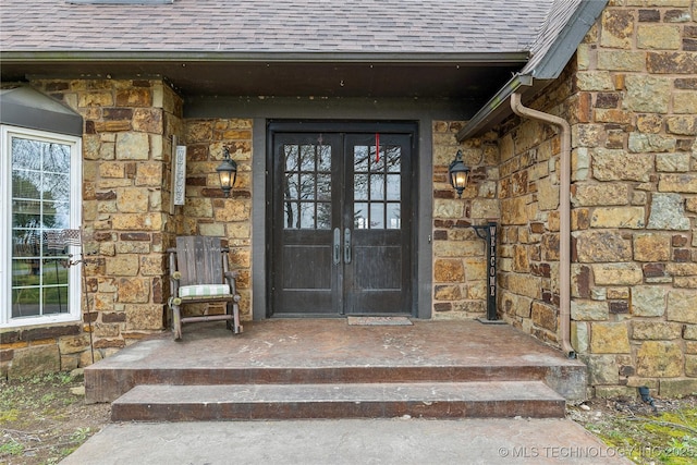 7133 S 425th Rd, Inola, OK 74036 - view of exterior entry with roof with shingles, stone siding, and french doors