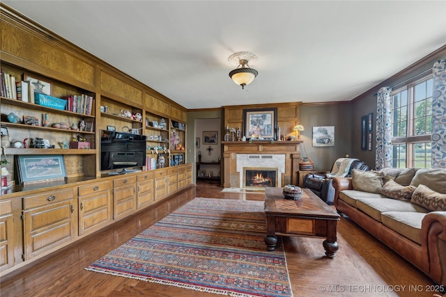 7133 S 425th Rd, Inola, OK 74036 - living room with a fireplace with flush hearth, dark wood finished floors, ornamental molding, and built in shelves