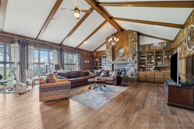 7133 S 425th Rd, Inola, OK 74036 - living area with high vaulted ceiling, ceiling fan with notable chandelier, a fireplace, beam ceiling, and dark wood-style floors