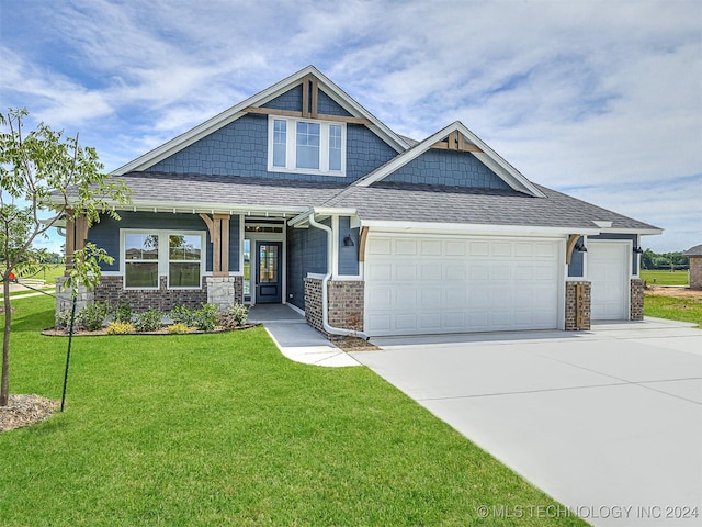 craftsman-style house featuring a front lawn and a garage