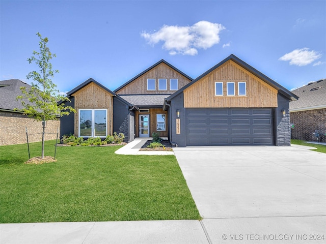 view of front facade with a garage and a front lawn