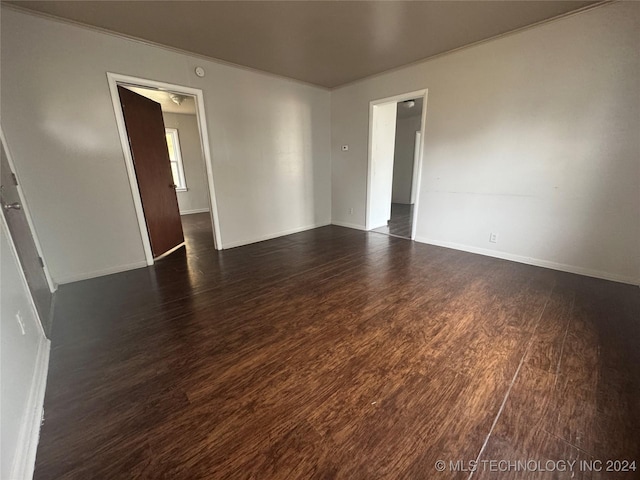 empty room with dark hardwood / wood-style floors