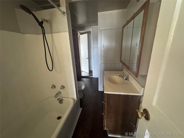 full bathroom with shower / bathing tub combination, vanity, hardwood / wood-style flooring, and toilet