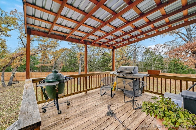 wooden deck featuring a grill