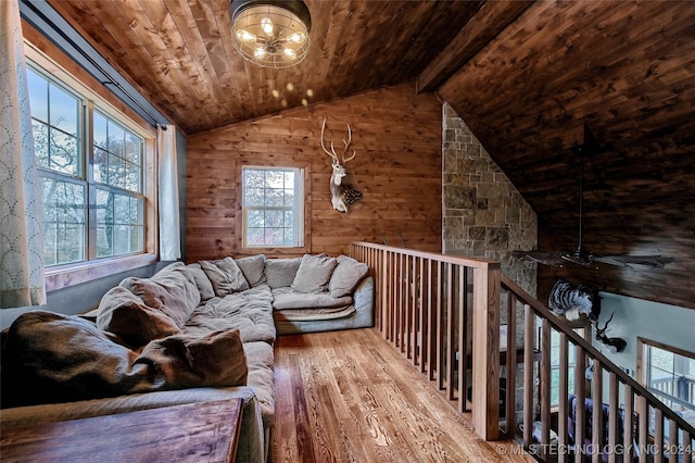 interior space with hardwood / wood-style floors, vaulted ceiling with beams, a wealth of natural light, and wooden ceiling