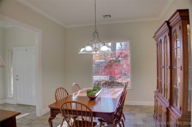 dining room with an inviting chandelier and ornamental molding